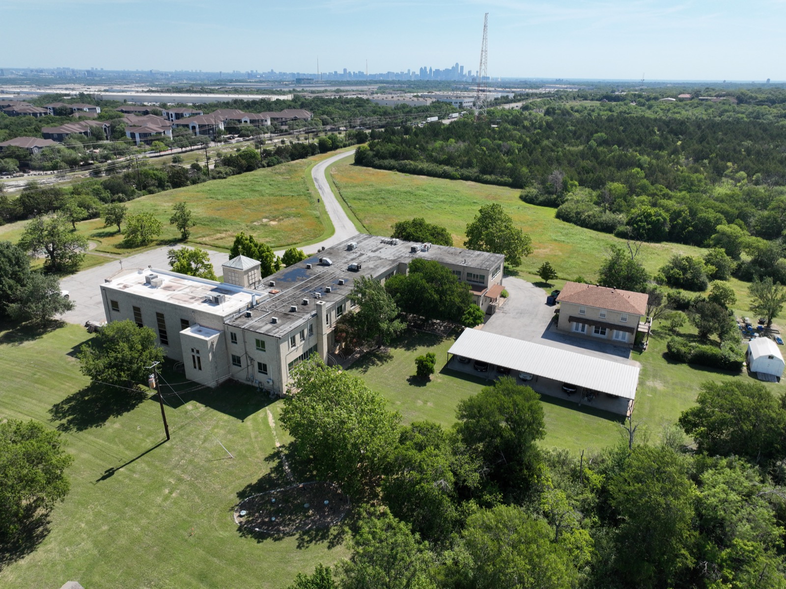 Aerial documentation of a commercial building site in Dallas with the downtown skyline in the distance